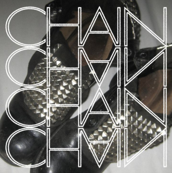 Chain cover: studded black boots under the word CHAIN repeated and mirrored in outlined capitals